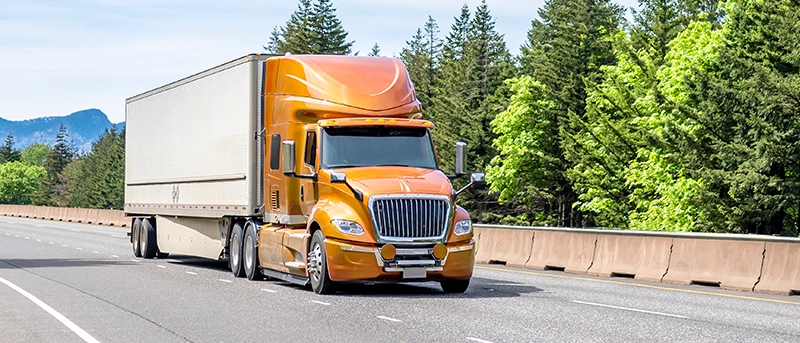 Regional truck driving down road
